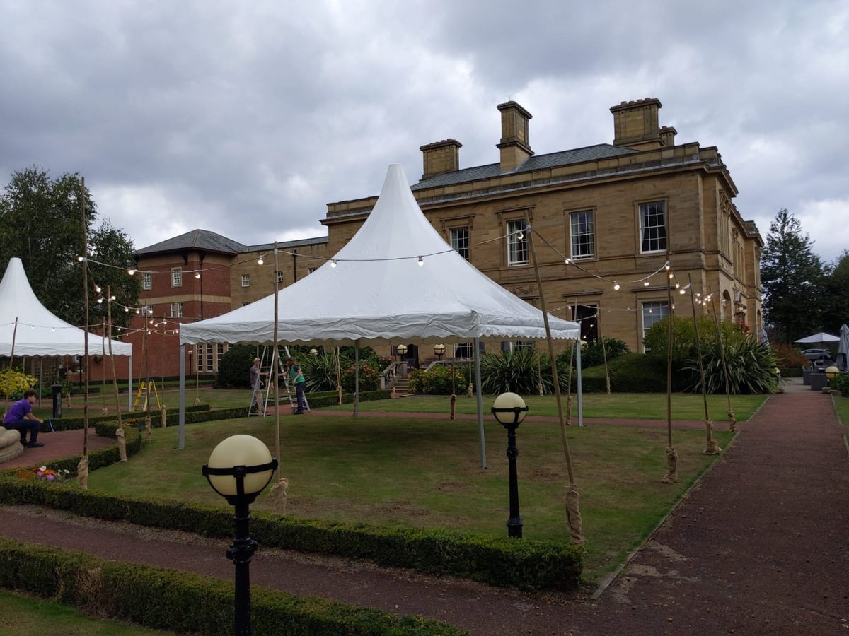 Pagoda marquees on the lawn in front of a stately home