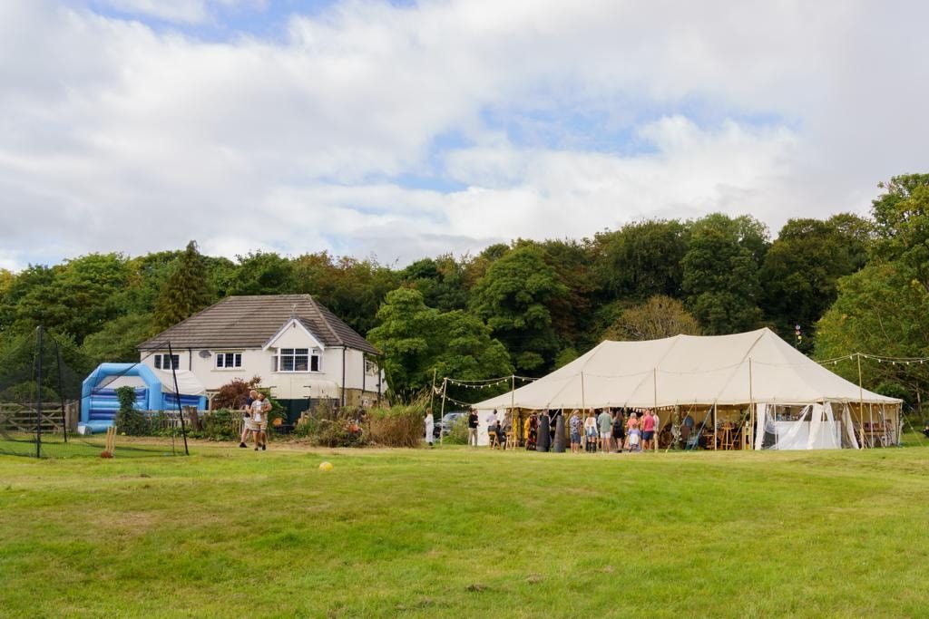 Traditional canvas pole marquee pitched on a lawn for a private party