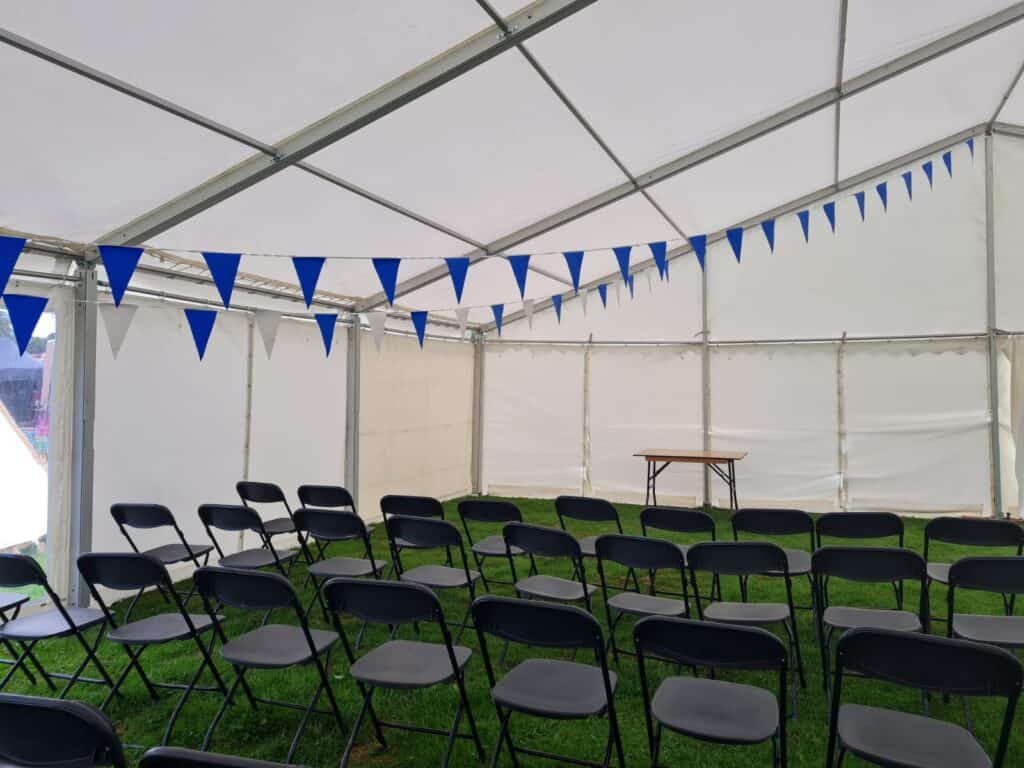 clear-span modular marquee decorated with blue bunting and chairs